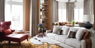 Hotel suite lounge area with parquet flooring and warm grey and tan accents