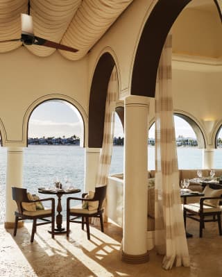 Table for two overlooking the Caribbean Sea through an open-air arch