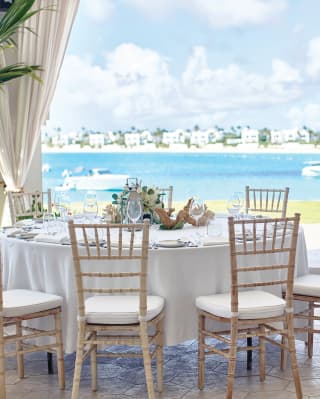 Circular tables set for a wedding with views of Maundays Bay