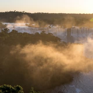 Mist rising from the Iguassu Falls at sunrise