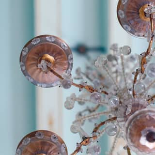 Close-up of a Murano glass chandelier against a powder blue ceiling