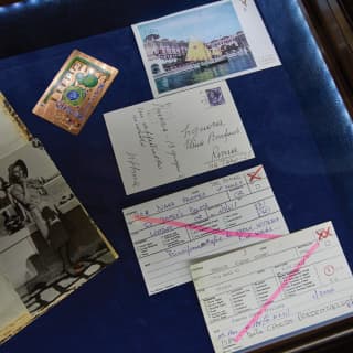 Postcards and mementos in a backlit glass display