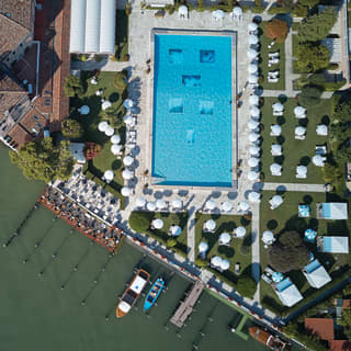Birds-eye-view of Hotel Cipriani with an olympic size pool beside the Venetian Lagoon