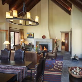 Double-height lounge and dining space decorated with Peruvian artwork and fabrics