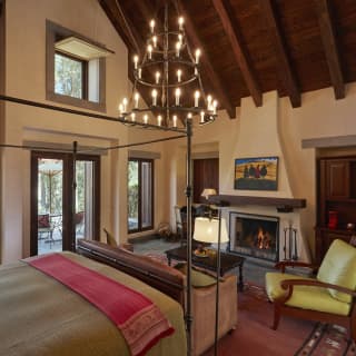 Spanish-colonial style hotel room with beamed ceiling and tiered candelabra