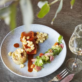 Circular plate of contemporary Peruvian cuisine. served with white wine