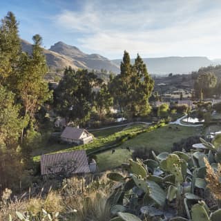 Casitas nestled into a verdant valley viewed from a hilltop