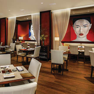 Restaurant with polished wood floor and white and red Asian-style decor