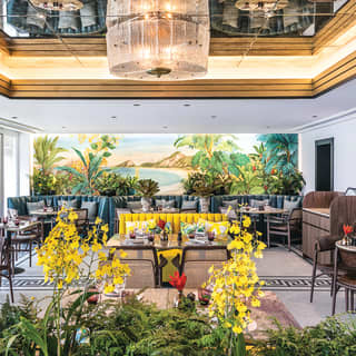 Stylish carioca restaurant with modern chandelier and gold and yellow accents