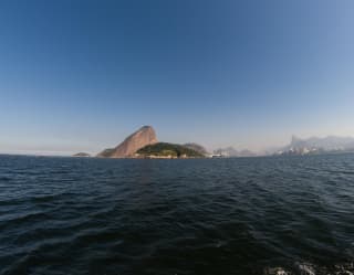 Mountains rising along the Rio de Janeiro coastline, viewed from across water