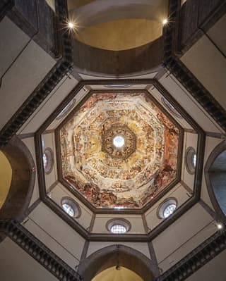 View from below of the ornate ceiling mural of the Il Duomo in Florence