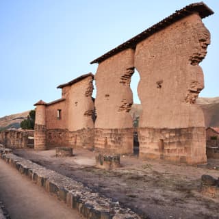 Ruins of the Temple of Wiracocha at the monumental Incan highway resting site of Raqchi, with towering walls of red stone.