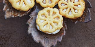 Birds-eye-view of flower shaped biscuits served on a ceramic leaf platter