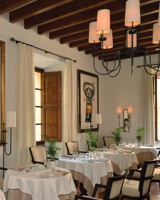 Light and fresh cafe interior with linen-coated tables and modern artwork on the walls