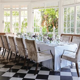 Wedding banquet table in a light-filled conservatory with checkerboard tiles