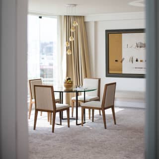 Stylish hotel dining area with pendant light chandelier and modern artwork