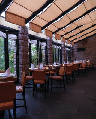 Tables at the hotel’s Restaurant Tampu look out a lush green view of the hotel gardens