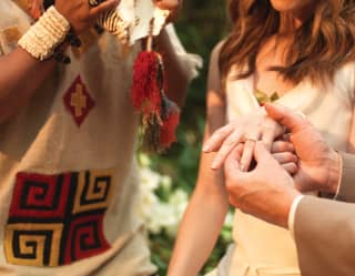 A groom slips a wedding ring on to his bride's finger in a ceremony including plenty of local colour and memories