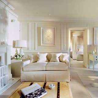 Light and airy hotel room with spacious lounge area entirely decorated in white