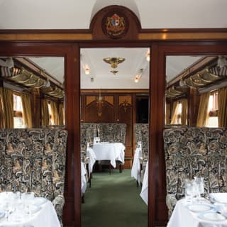 Grand vintage train carriage with liberty print furnishings and gleaming brass details