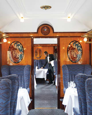 View through the aisle of an original Pullman carriage with gleaming wood panels
