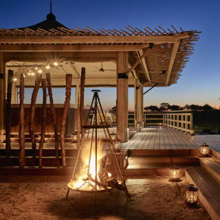 After dark the terrace is romantically lit by lanterns and flaming braziers