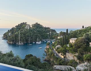 Hilltop view of an Italian bay at sunset with yachts and sailboats on the water