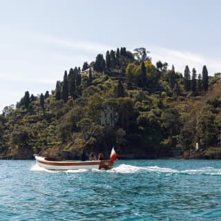 Two men and a lady in smart casual outfits relaxing on a traditional gozzo boat