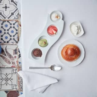 Birds-eye-view of ice cream scoops served in a curved white platter dish